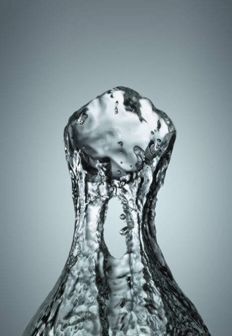 Ice cube dropped into water